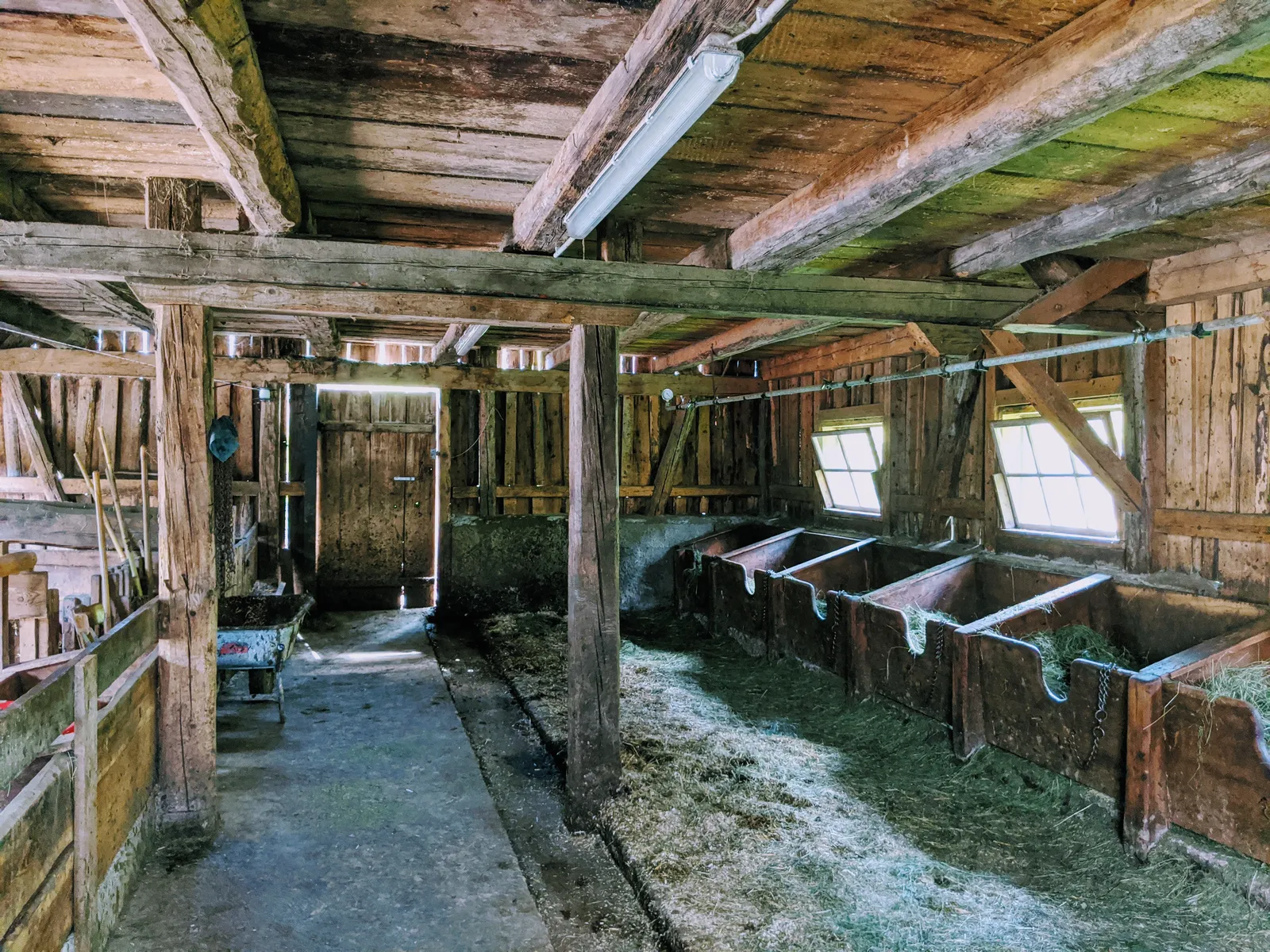 Old alpine stable interior with wooden beams