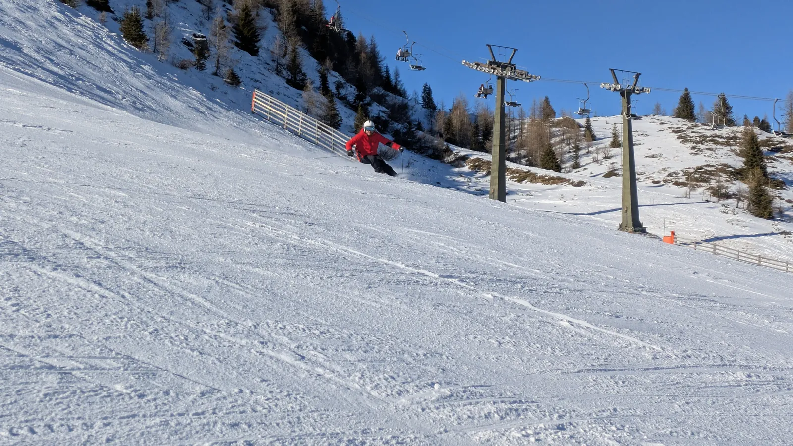 Skier on a snowy slope near a ski lift
