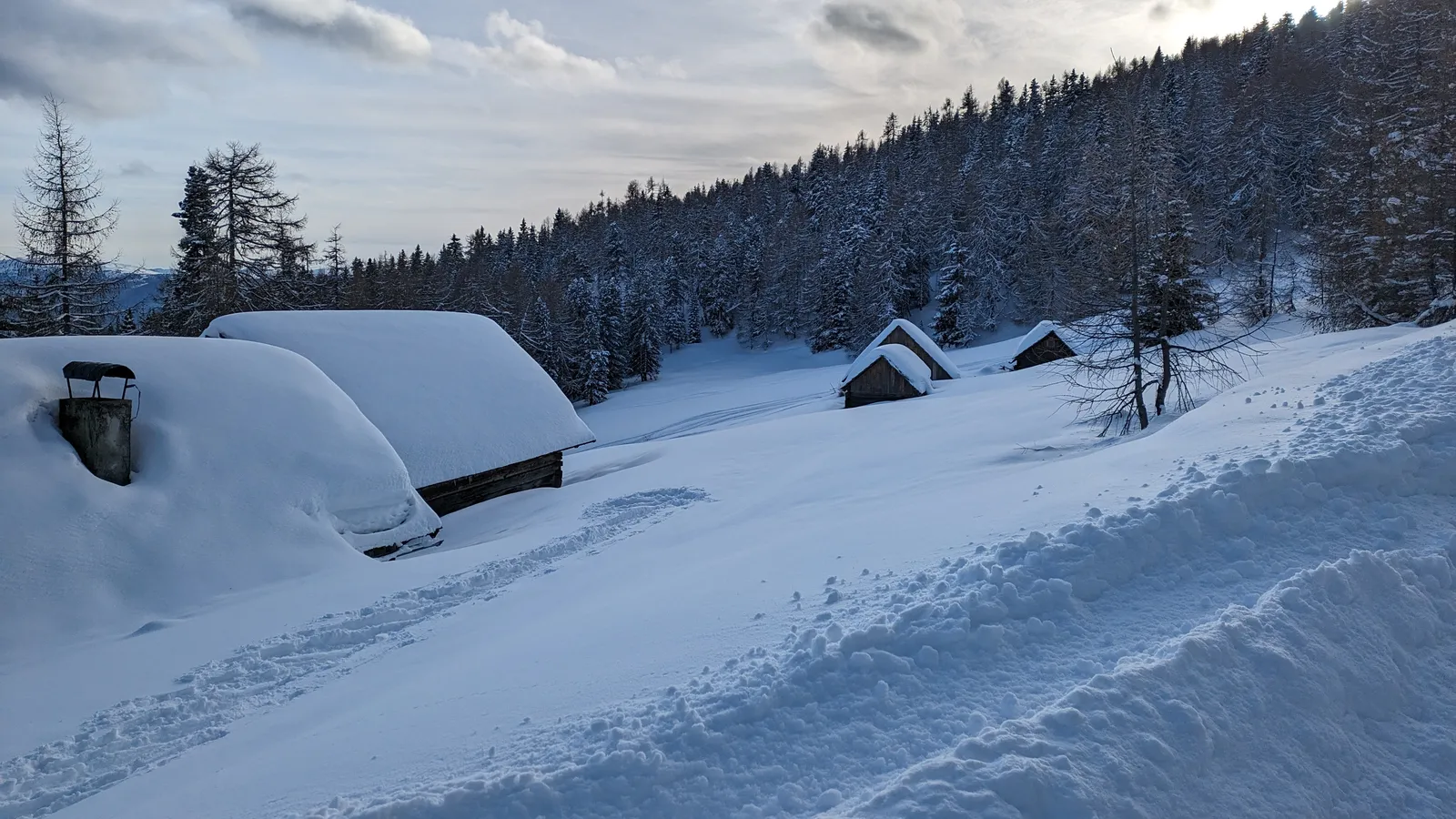 Small huts partly buried in deep snow