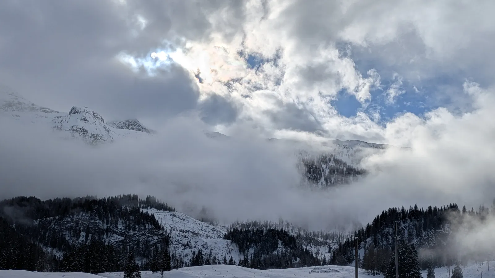 Clouds parting over winter mountains